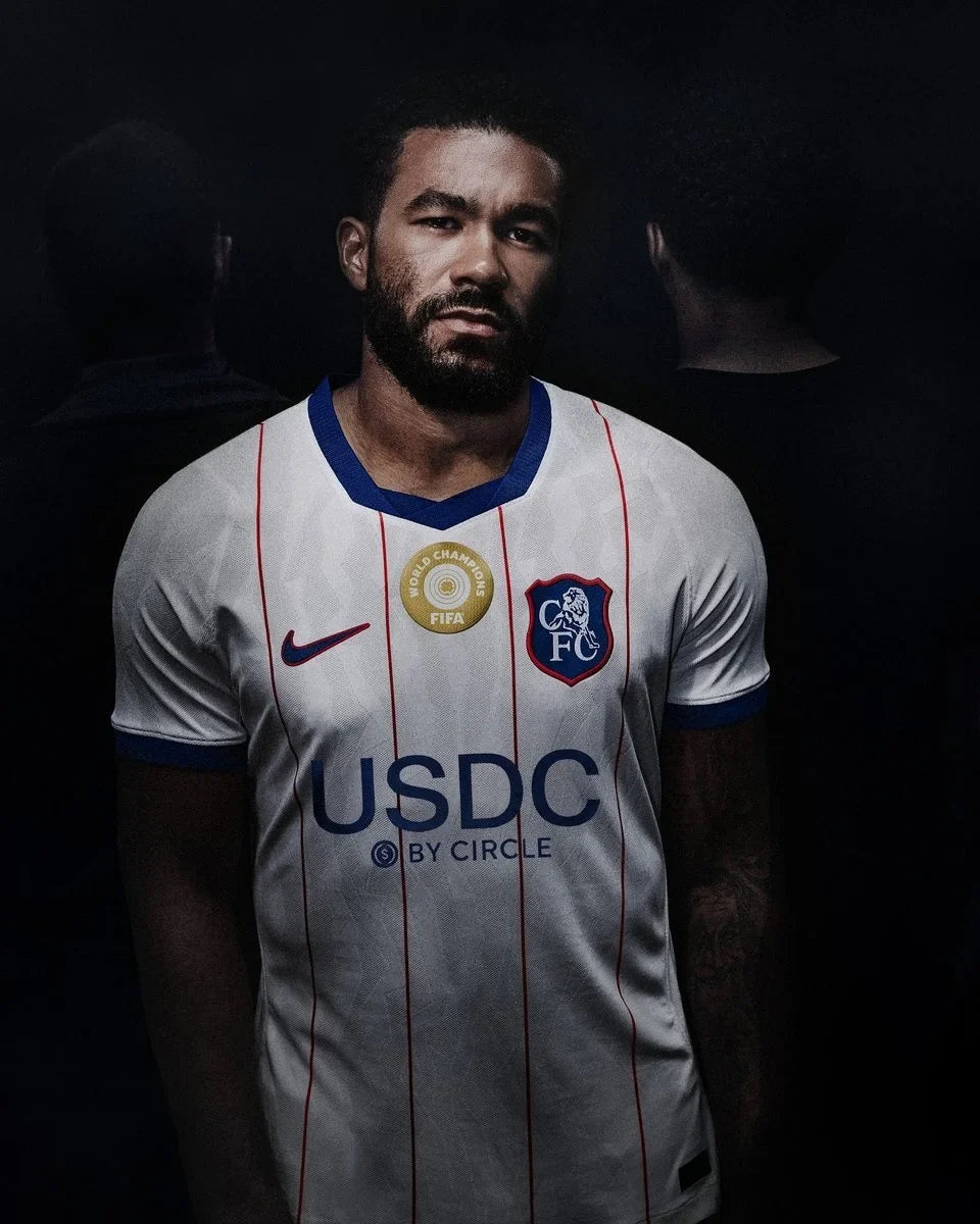 Chelsea 2026/27 white third jersey with red pinstripes, World Champions badge and retro shield crest