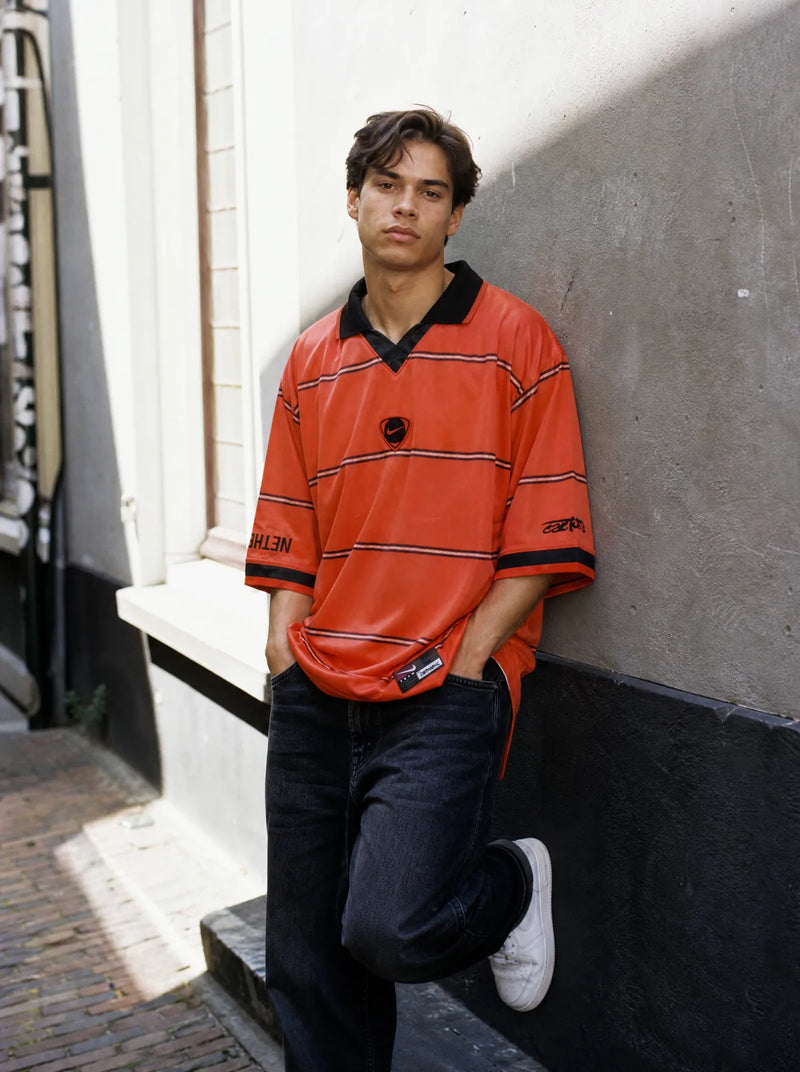Cactus Jack × Total 90 — oranje gestreept shirt